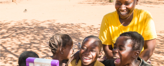 Woman laughing with children